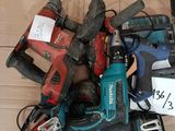 a pile of power tools on the floor with price tags