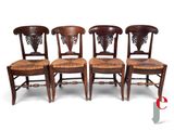three wooden chairs with wicker seats are lined up against a white background