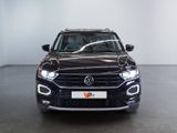 the front of a black volkswagen suv parked in a showroom