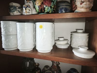 many different types of vases on this shelf