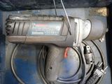 a drill with a cord attached to it in a box