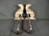 pair of antique cast iron dog bookends on black background