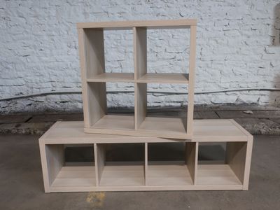 two bookshelves stacked on top of each other in a room