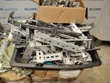 a pile of assorted metal parts in a box