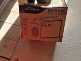 a person standing next to a box that has a radio inside of it