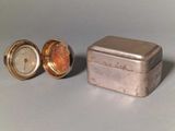 a small metal box with a clock inside of it