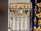 many different types of jewelry hanging on the wall