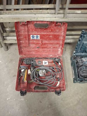 a red tool box with tools in it on the floor