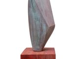 sculpture of a rock on a wooden base on a white background