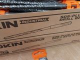 a box of drill bits sitting on the floor next to a box of drill bits