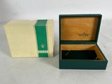 an open box with a watch inside of it on a white surface