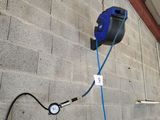 a blue hose attached to the wall of a building