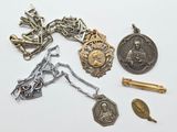 a lot of silver and gold items on a white surface