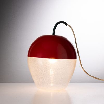 une lampe rouge et blanche posée sur une table