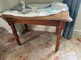 a small table with a cloth on it and a candle on it