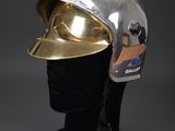 silver helmet on a mannequin head with a gold helmet on it