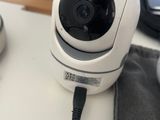 a white camera sitting on top of a desk next to a keyboard