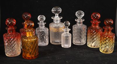 several different colored glass bottles sitting next to each other on a black surface