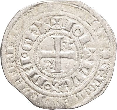 a close up of a coin with a cross on it
