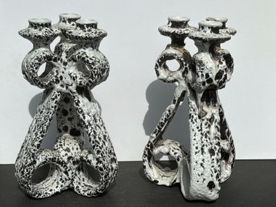 two vases that are sitting on a table