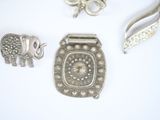 a lot of silver items that are on a white surface