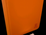 an orange binder with a note pad on it