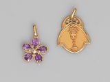a pair of gold and amethe charms