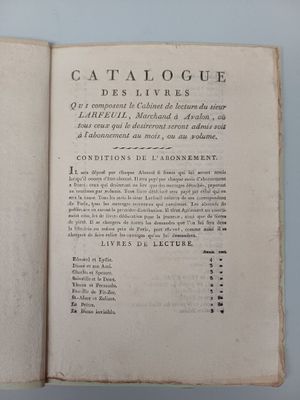 an open book with a black and white image of a cat sitting on top of it