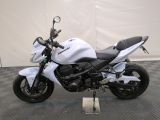 a white motorcycle that is parked on a black and white checkered floor