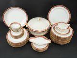 a group of white and gold plates and bowls with gold rims