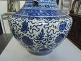 a blue and white vase sitting on a white table