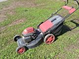a lawn mower that is sitting in the grass