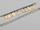 a silver bracelet with five coins and a chain