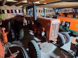many old tractors in the garage of this house