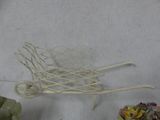 a small white wheelbarrow with a basket of flowers on it