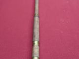 an image of an old cane on a red cloth