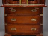 an antique mahogany bureau with brass handles and drawers