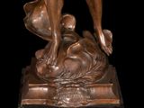 bronze statue of a woman holding a baby on a marble base