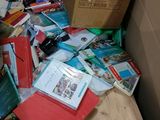 a pile of books on a table next to a cardboard box