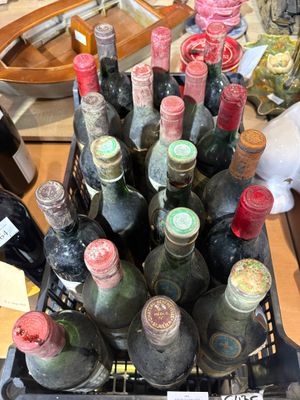 many bottles of wine in a basket on the table