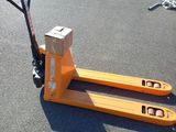 a pallet that is sitting on the ground with a pair of scissors