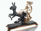 statue of a horse pulling a cart with a man on it ' s back