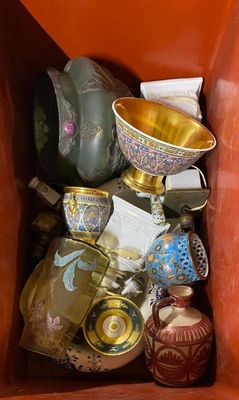 a red box filled with different types of vases and bowls