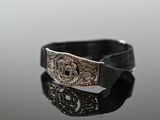 a close up of a silver buckle on a black belt