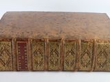 an old book sitting on top of a white table