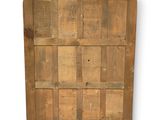an old wooden door with a lot of wood panels on it