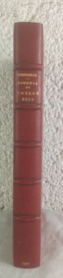 a stack of red books sitting on a white table