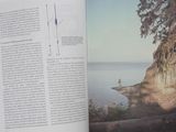 an open book with a picture of a person standing on a cliff