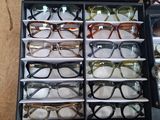 many pairs of glasses in a case on the table