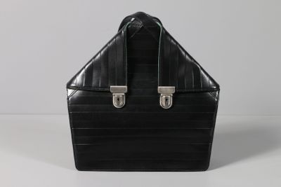 black leather briefcase with silver handles on a white surface